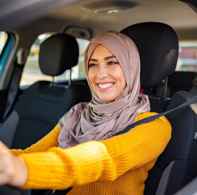 A happy woman driving car